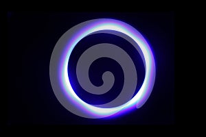 Blue circle of light against a black background.