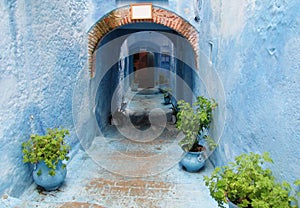 Blue city street with walls and arch