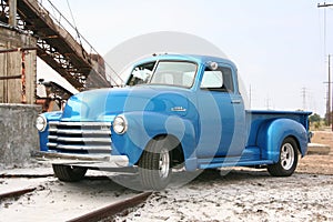 Blue classic pickup on train track