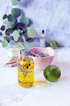 Blue clay, citruses, cream, aromatic oil, healthy tinctures and seashells on a light background, spa