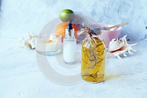 Blue clay, citruses, cream, aromatic oil, healthy tinctures and seashells on a light background, spa