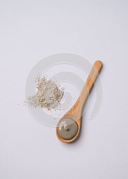 Blue clay in a spoon on a light background. Concept for preparing homemade skincare organic cosmetics and spa treatment
