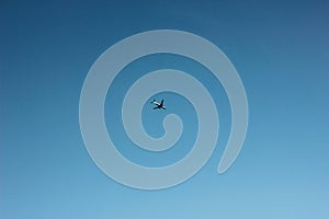 Blue clear sky with flying plane, background