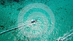 Blue clear water with a fishing boat. Aerial view from the drone.