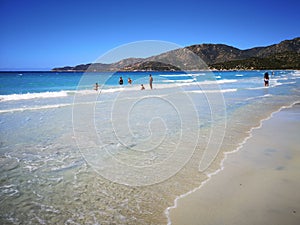 The blue clear water and white sand of a beach in Sardinia