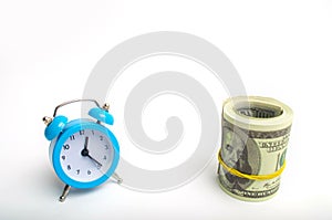 blue clock and dollars on a white background. the concept of `time is money`. business financial ideas. saving. Financial investme