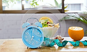 Blue clock  for  fast intermittent  hour feeding window concept or breakfast time with clock
