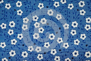 Blue cloth texture background with white flowers striped