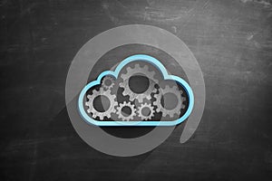 Blue cloud icon on blackboard with cogwheels