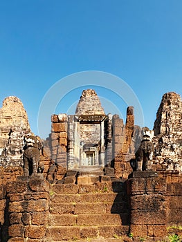 Blue cloudless sky over ancient Khmer ruins, stone steps, East Mebon