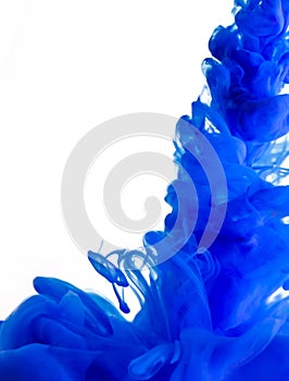 Blue clouds of ink in liquid isolated on white