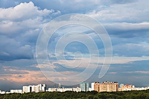 Blue clouds in pink sky over town