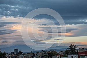 Blue clouds of a sunset over the city buildings photo