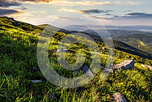 Blue cloudy sky over the mountains with rocky hillside