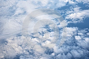 Blue cloudy sky, view from the airplane window. Aerial view of cloudscape