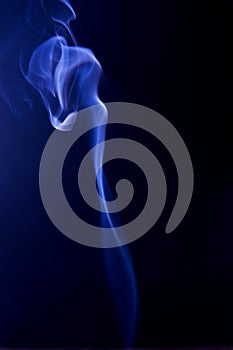 Blue clubs smoke on a black background. Fluid effect.