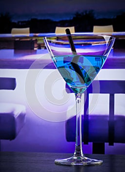 Blue cocktail drink on a lounge bar table with space for text