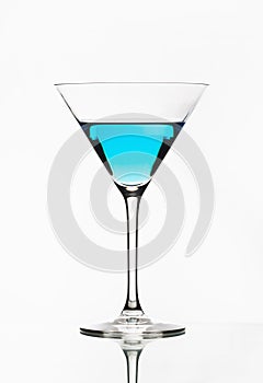 Blue cocktail isolated on white. One blue cocktail martini isolated.