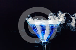 Blue cocktail with splash and ice vapor photo