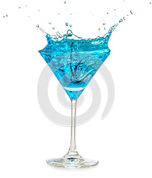Blue cocktail splashing in martini glass