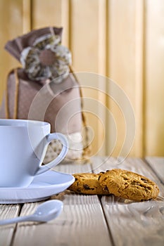 Blue coffee cup with cookies and bag