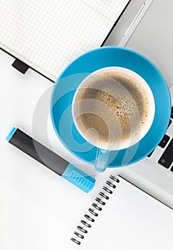 Blue coffee cup and office supplies