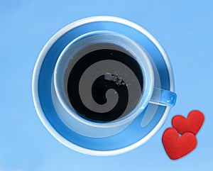 Blue coffee cup with small red hearts (Love concept)