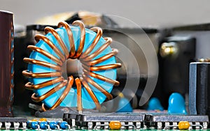 Blue coil core with copper wire winding and integrated circuits photo