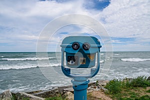 Blue coin operated binoculars for viewing the beautiful blue sea