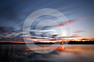 Blue cold sunrise over lake