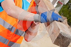 Blue-collar worker holding a wooden beam