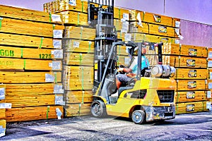 Blue Collars finistest fork lift driver grabs another stack of lumber