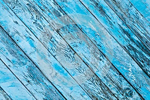 Blue color old wooden diagonal planks with peeled paint background