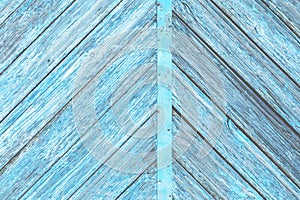 Blue color old wooden diagonal to both sides planks with peeled paint background