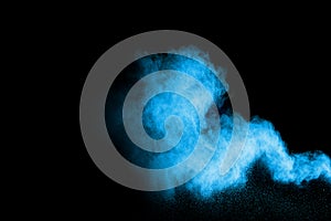 Blue color powder explosion cloud isolated on black background