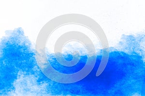 Blue color powder explosion cloud on white background.Closeup of Blue dust particles splash on background