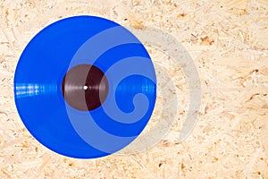 Blue color vinyl record on plywood background