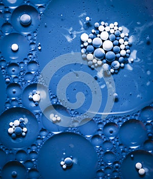 Blue colored bubbles in oil