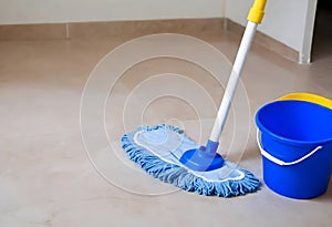 Blue Colored Bucket With House Cleaning Products On Hardwood Floor At Home