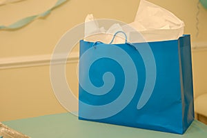 Blue colored gift bag with gift wraps