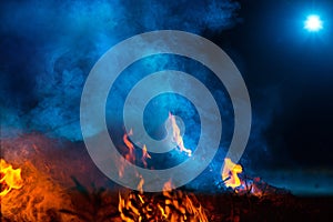 Blue colored smoke wuth fireflames