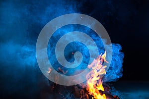 Blue colored smoke wuth fireflames