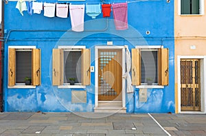 Blue colorful house of Burano Island with laundry, Venice, Italy