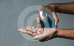 Blue coloured gel sanitiser pumping with finger to squeeze of the gel to wash the hand