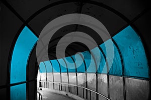 Blue colours painted in the wall of a curvy walking tunnel in India