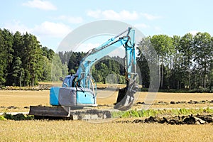Blue Compact Excavator at Work