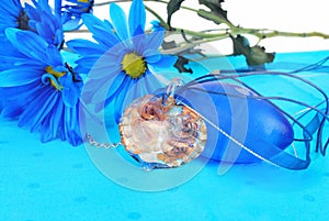 Blue composition with heart pendant.