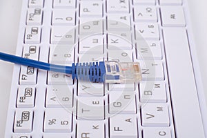 Blue computer cable on keyboard