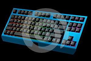 Blue computer keyboard with rgb colors isolated on black background.