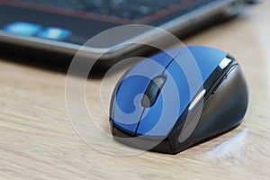 Blue computer mouse and laptop